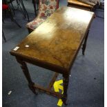 An Edwardian walnut and mahogany Games Table, the quarter veneered walnut Twist-Top folding over