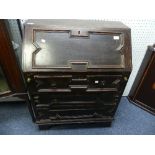 An early 20thC oak Bureau, with fall front top above three long drawers, raised on bracket feet,