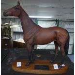 A Beswick Connoisseur figure of Red Rum, on wooden plinth mounted with informative plaque, 12in (
