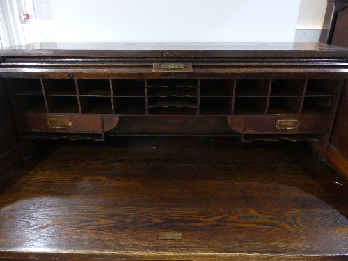 An early 20thC American oak roll top Desk, marked 'Cutler', the serpentine tambour front revealing - Image 5 of 5