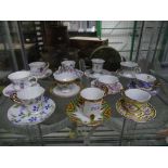 A quantity of Miniature Tea Cups and Saucers, mostly from the Miniature Museum of Mayfair, decorated