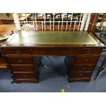 A Georgian style mahogany twin pedestal Desk, the front arranged into nine various drawers, the