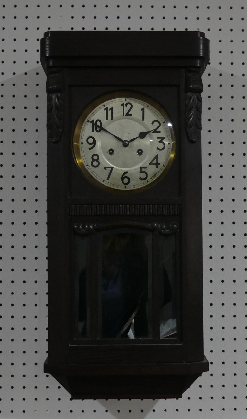 An early 20thC oak Wall Clock, circa 1920's, the silvered dial with Arabic Numerals, striking on a