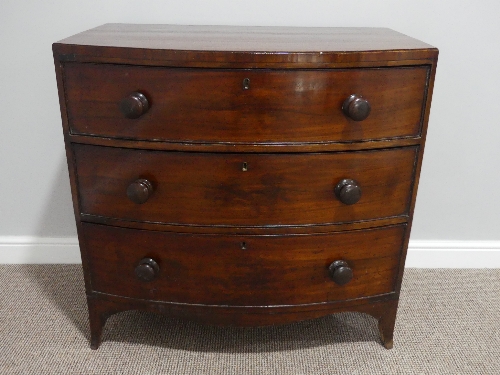 A Victorian mahogany bow front Chest of Drawers, with three long drawers, bracket feet and wooden