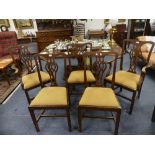 A set of five George III mahogany dining chairs, including two carvers, each with a pierced splat,