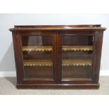 A Victorian mahogany two door glazed Bookcase, the two adjustable shelves with gilt leather
