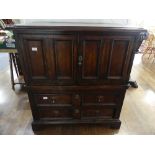 A 19th century oak Carolean style Panelled Chest, with two cupboard doors above two long drawers