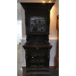 A Victorian Jacobean style carved oak upright Cabinet, with moulded cornice, single leaded glass