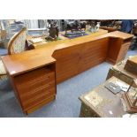 Mid 20thC Design: a retro Danish teak Bedhead, with integrated three-drawer bedside cabinets on