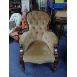 A Victorian walnut upholstered Armchair, the spoon back with scrolling show frame, scrolling arm