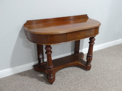 A Victorian mahogany demi-lune Dressing Table, with single frieze drawer and fluted column supports,