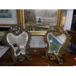 A pair of early 20th century gilt metal Easel Mirrors, with bevelled edged plates, each of foliate