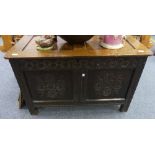 An antique oak Coffer, 17th century and later, the hinged two-panel top above a carved frieze and