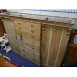 A Victorian pine triple compactum breakfront Wardrobe, the central set of seven graduated drawers