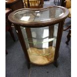 An Edwardian mahogany kidney shaped Bijouterie Display Cabinet, the bevelled glass top above a