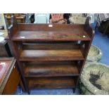 An Arts & Crafts style oak Open Bookcase, with four shelves and decorated with trefoil shaped cut