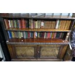 A Victorian rosewood Bookcase, two open shelves upon two doors enclosing shelved interior, 53in (