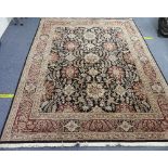 A large hand-knotted Persian-style wool Rug, black ground with dark rust and light gold stylized