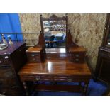 An Edwardian mahogany Dressing Table, the rectangular swing mirror with two small drawers on