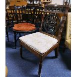 An early 20thC oak Hall Chair, with pierced ecclesiastical style back and raised on brass castors,