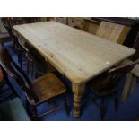 A vintage stripped pine Kitchen Table, with two frieze drawers on one long edge, turned legs,