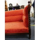 An early Victorian mahogany and rosewood show-frame Sofa, with upholstered back, arms and seat,