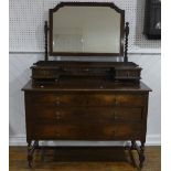 A vintage oak Dressing Table, the swing mirror with barley twist supports above two small drawers,