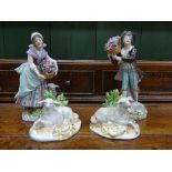 A pair of 20thC Sitzendorf Figures, depicting a shepherd and a shepherdess in bocage with sheep at