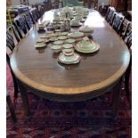 A large Edwardian mahogany D-end extending Dining Table, the mahogany and cross banded top, upon