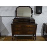 A vintage oak Dressing Table, the swing mirror with barley twist supports above two small drawers,