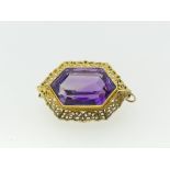 A Victorian amethyst Pendant / Brooch, the central hexagonal facetted amethyst in a scrolling