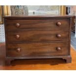 An early 20thC miniature mahogany Apprentice-piece Chest of Drawers, the three long drawers