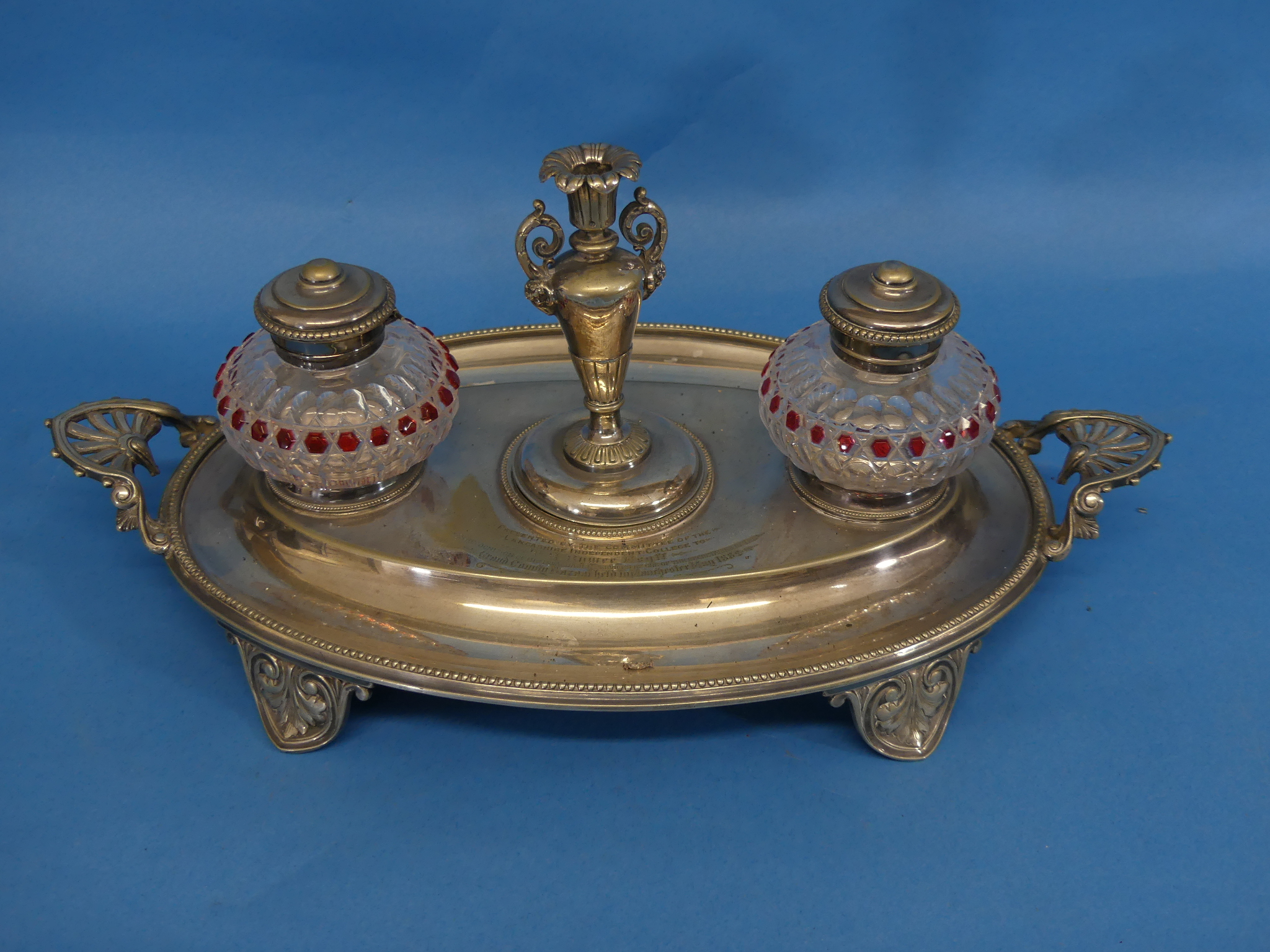 A Victorian silver-plated and cut glass Inkstand, of oval form, the two ink pots flanking a taper