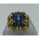 A large synthetic spinel Dress Ring, the central step cut stone, 12mm x 10mm, in an elaborate