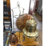 A brass bell-shaped Charcoal burner on circular cast iron stand, 28in (71cm) high, together with a