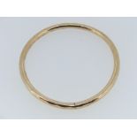 A 9ct rose gold hollow Bangle, with inscription, approx weight 9.5g.