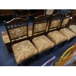 A set of four late Victorian walnut Parlour Chairs, the carved top rail upon spindle supports,