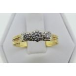A three stone diamond Ring, the graduated stones illusion set in 18ct yellow and white gold, Size S,