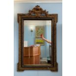 A Louis XVI style giltwood and gesso wall mirror, the rectangular mirror plate within a moulded