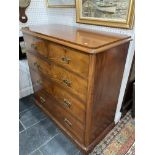 A Victorian flame mahogany Chest of Drawers, the rounded rectangular top above two short and three