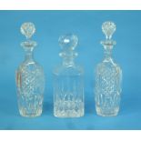 Three cut-glass Decanters, two matching, with round bases, height 12in (30cm), together with another