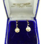 A pair of 9ct yellow gold Earrings, with shaped gold flowerheads, with central cultured pearl, screw