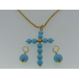 A large turquoise cross Pendant, formed of ten uniform turquoise beads, with gold central bead,