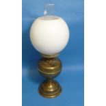A Victorian brass Oil Lamp, with white glass globe and clear funnel, 19½in (49.5cm) high.