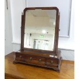 A 19th century mahogany gentleman's Toilet Mirror, the rectangular base with three drawers on ogee