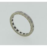 An 18ct white gold Eternity Ring, set all around with small diamond points, marked on the