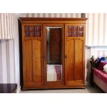 A late Victorian mahogany Compactum Wardrobe, with glazed doors and central mirrored door, mirror