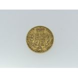 A Victorian gold Sovereign, dated 1859, with shield back.