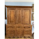 A George III oak Housekeepers Cupboard, the two fielded panel doors with mahogany banding opening to