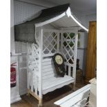 A vintage white painted wooden garden Arbour, 90in (228.5cm) high x 66in (167.5cm) wide x 40in (